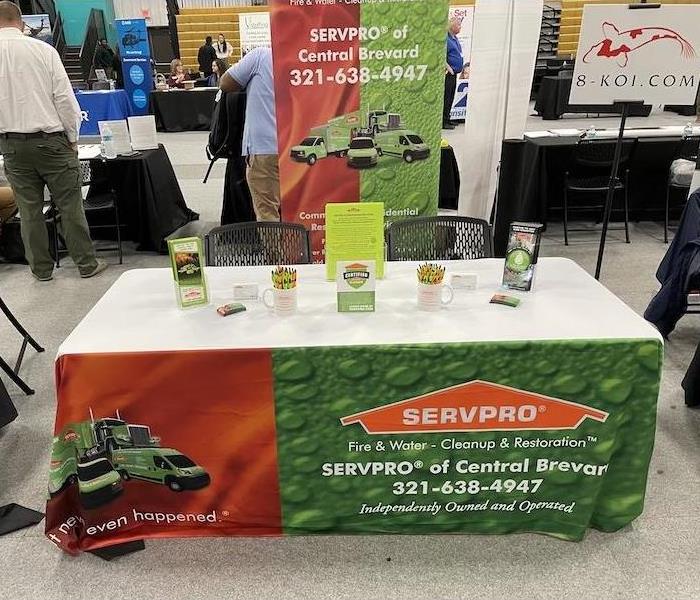 table with SERVPRO tablecloth and promotional materials