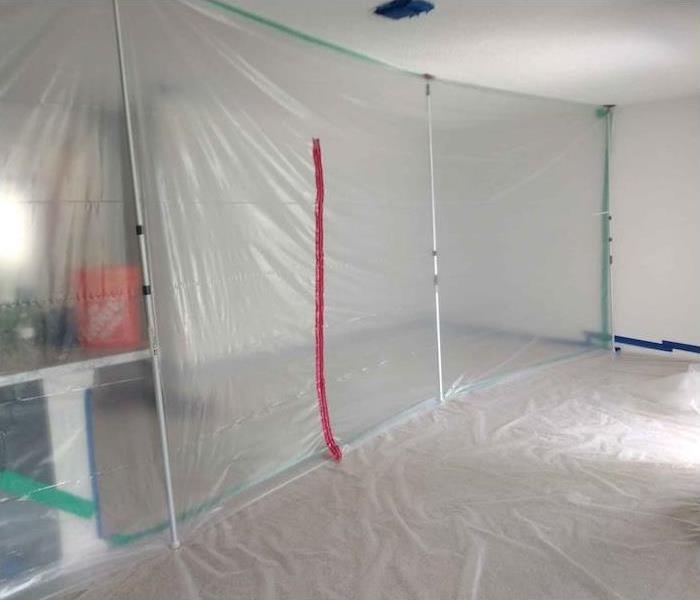 Room with plastic containment barriers setup